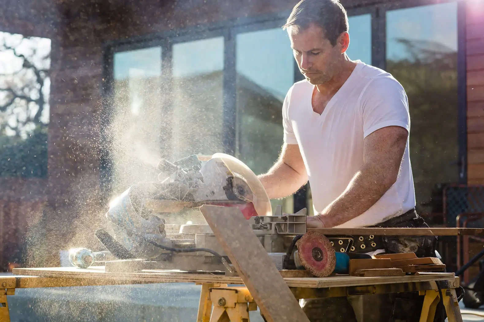 Greg Gallo, founder of GHG Builders, cutting timber on site