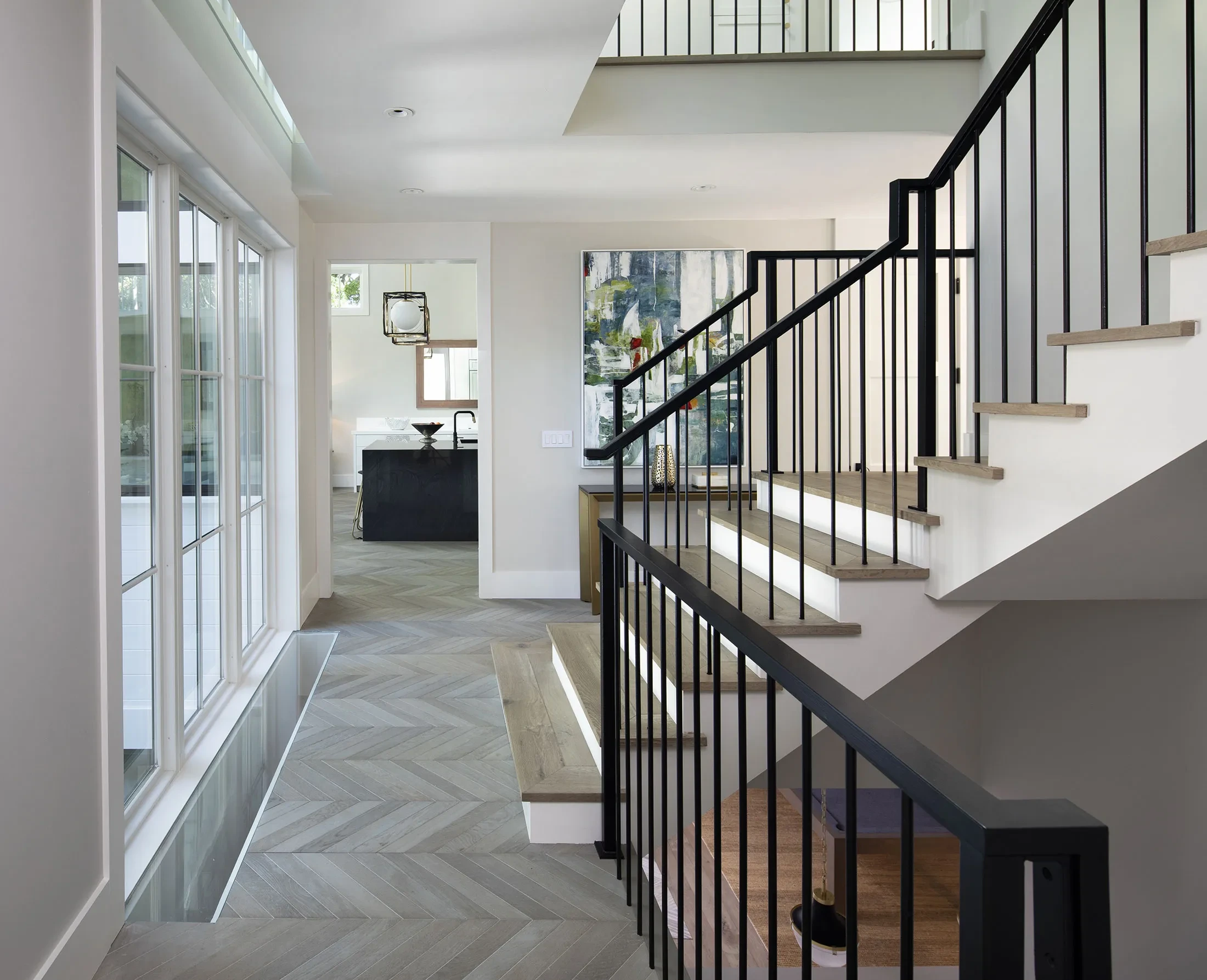 Byron by GHG Builders — entry hall and staircase with black metal balustrade