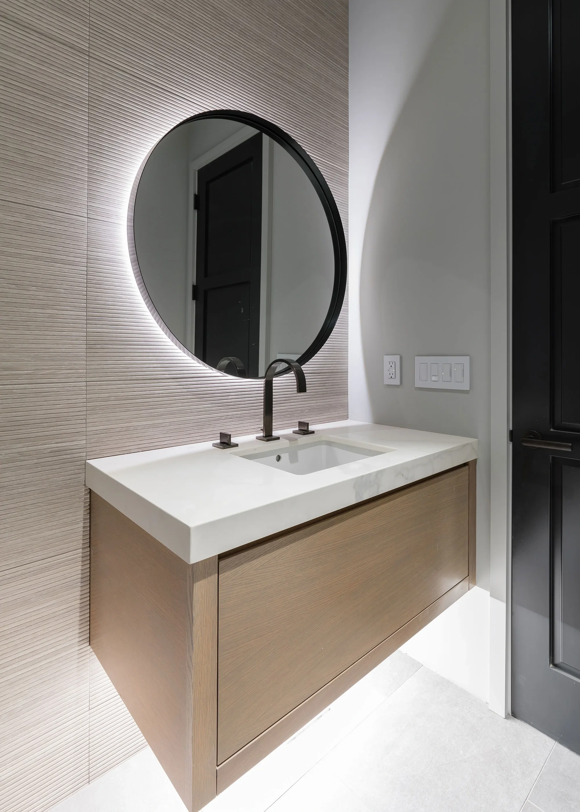 Hesketh by GHG Builders — powder room with backlit round mirror