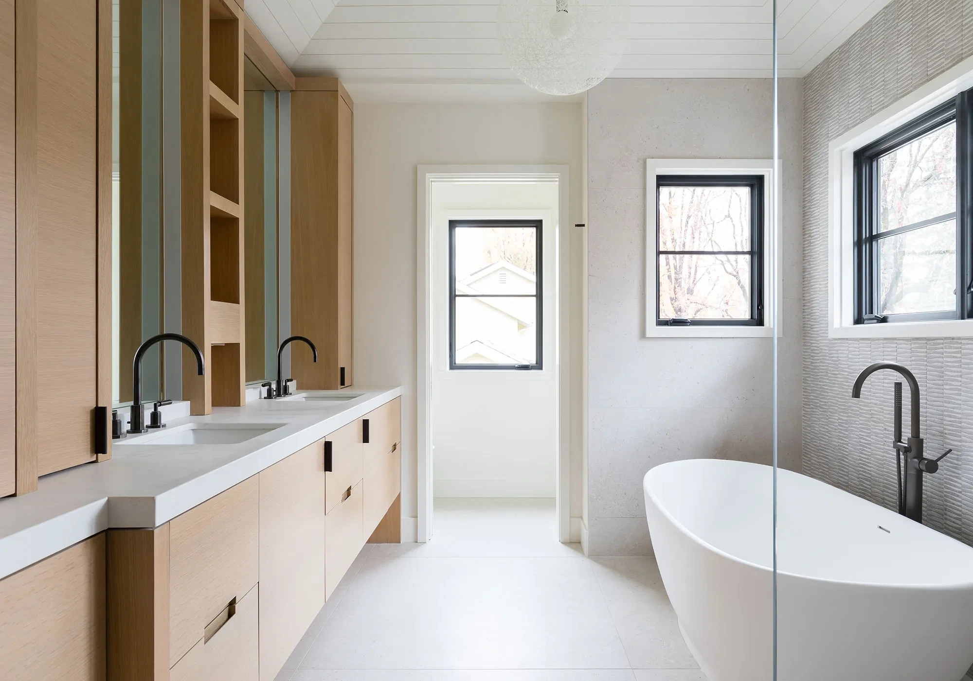Hesketh by GHG Builders — primary bathroom with freestanding tub and twin vanities