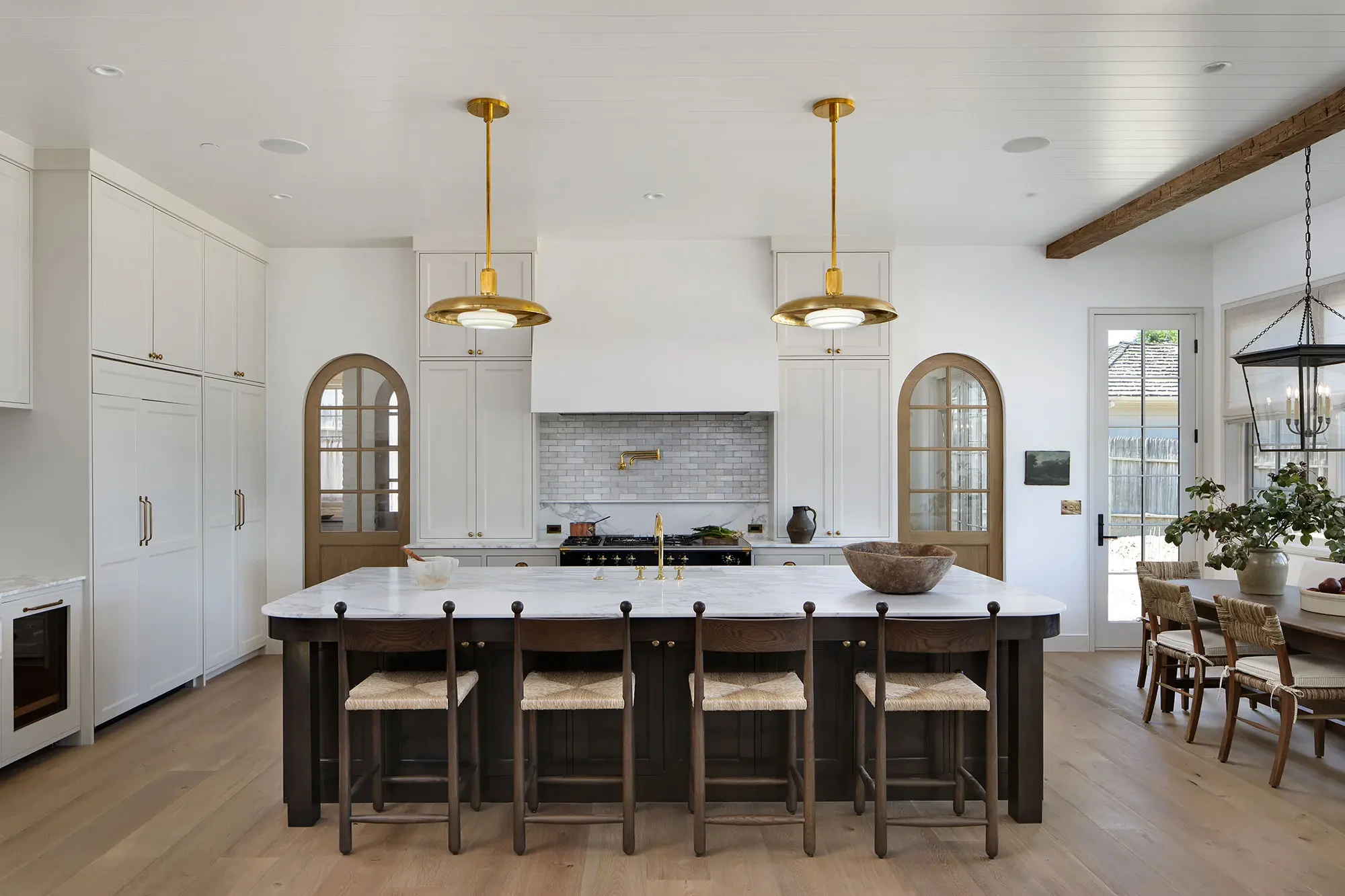 La Mesa by GHG Builders — kitchen with marble island and brass pendants