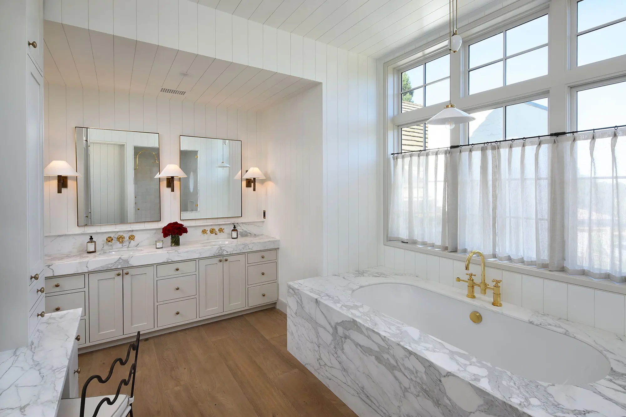 La Mesa by GHG Builders — primary bathroom with marble-clad tub