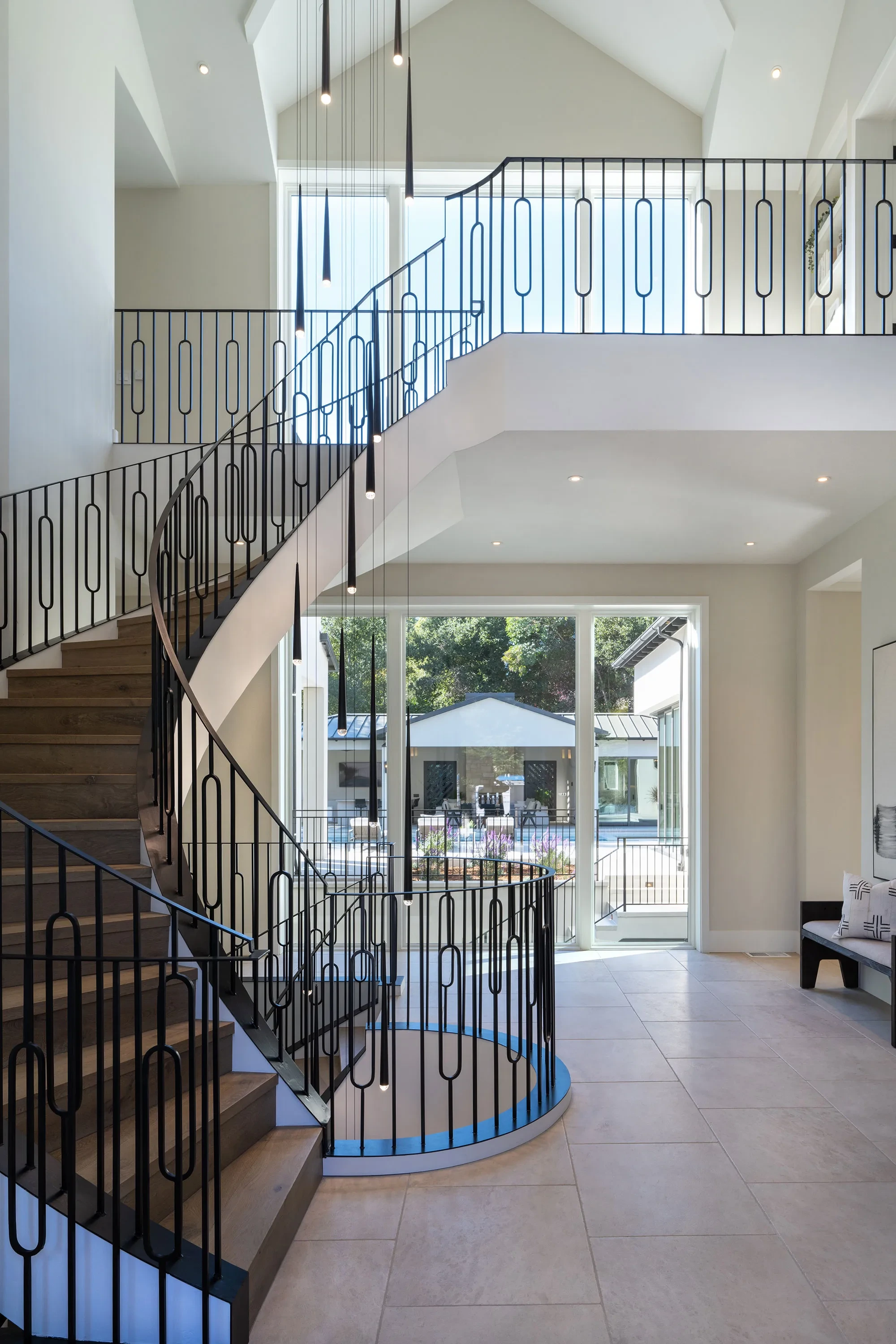 Shearer by GHG Builders — curved staircase with wrought-iron balustrade