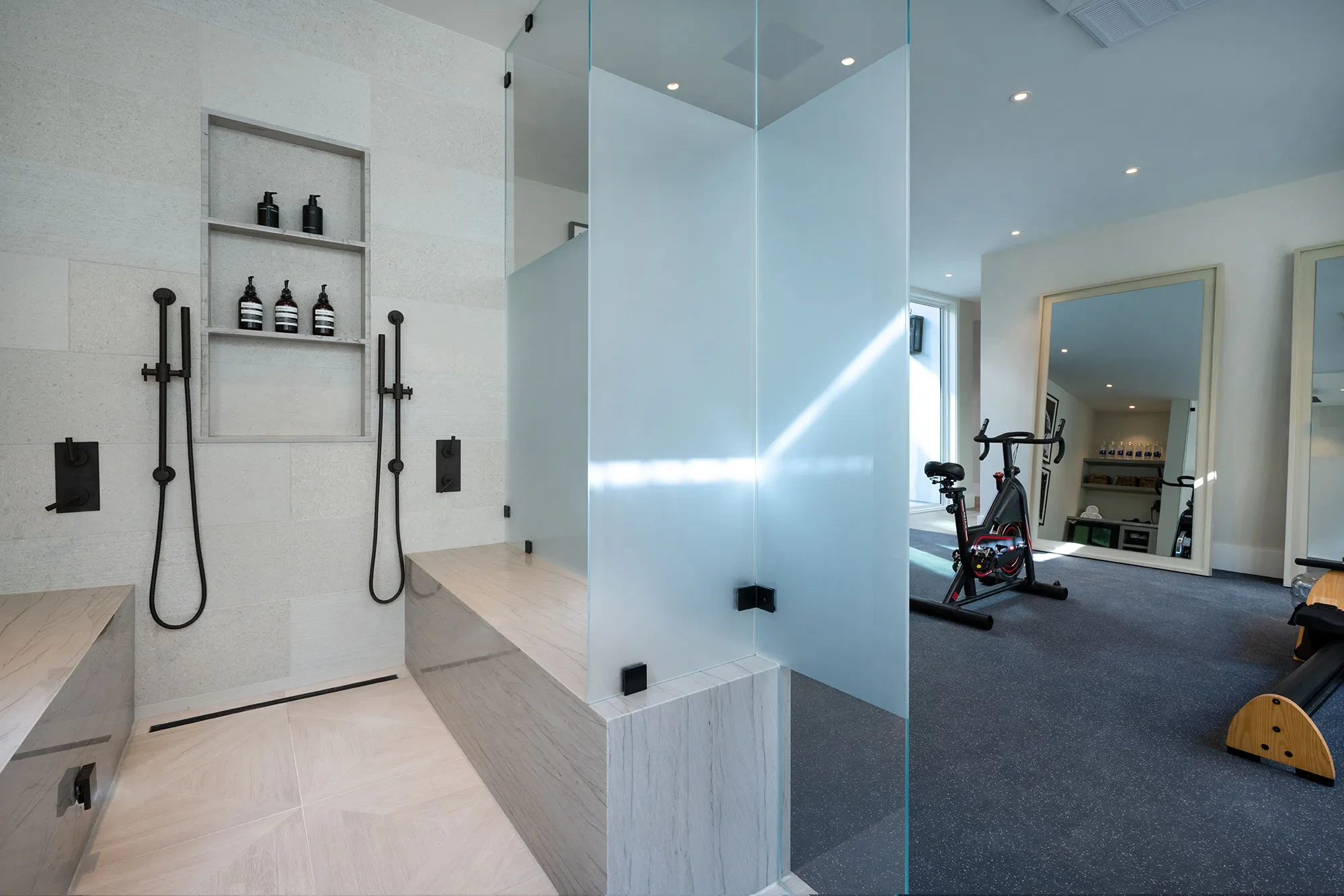 Shearer by GHG Builders — walk-in shower with the home gym behind glass