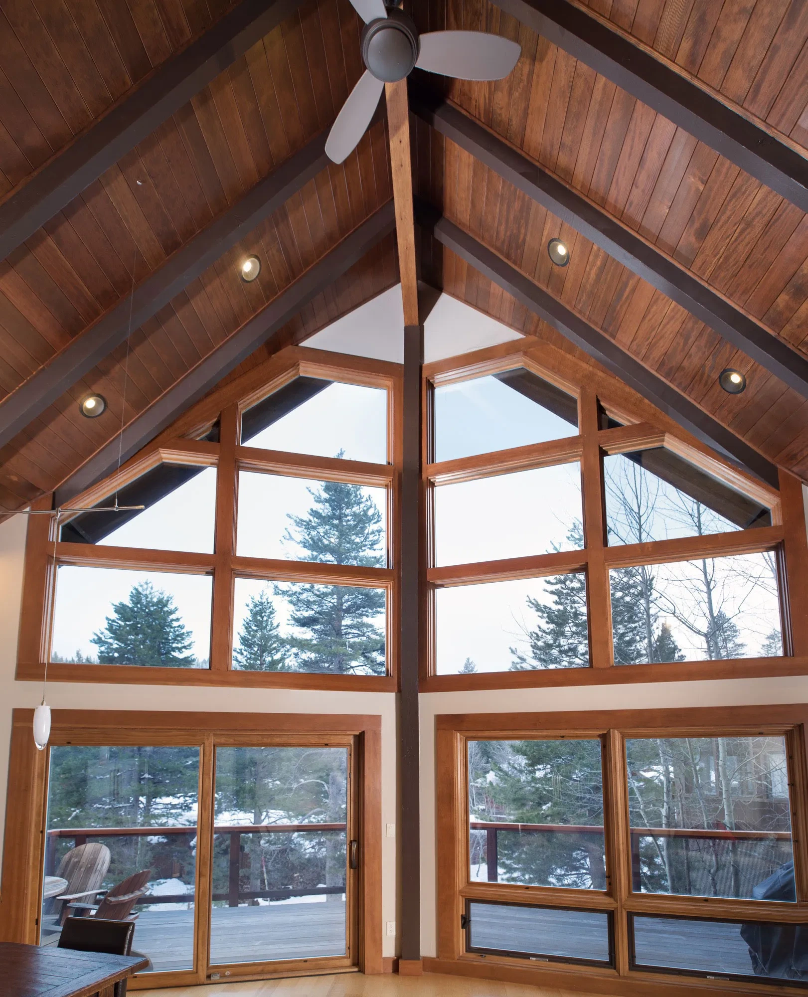 Tiger Tail by GHG Builders — A-frame great room with full-height glazing onto the snow