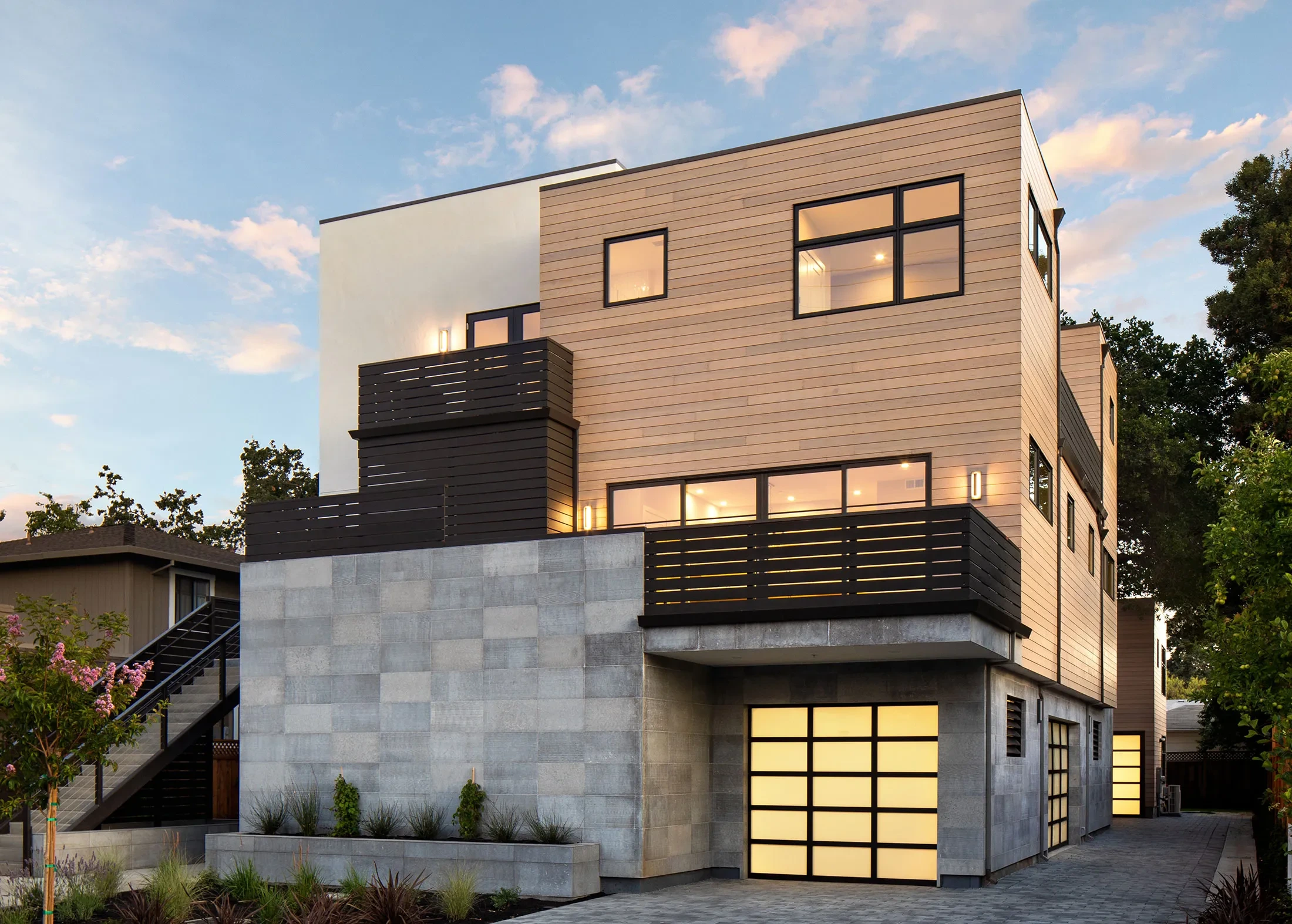 University Drive by GHG Builders — modern multi-family front elevation at dusk