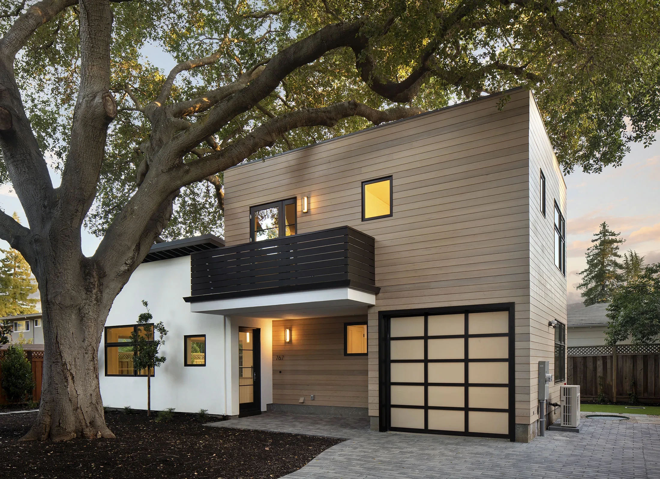 University Drive by GHG Builders — exterior beneath a mature oak at dusk