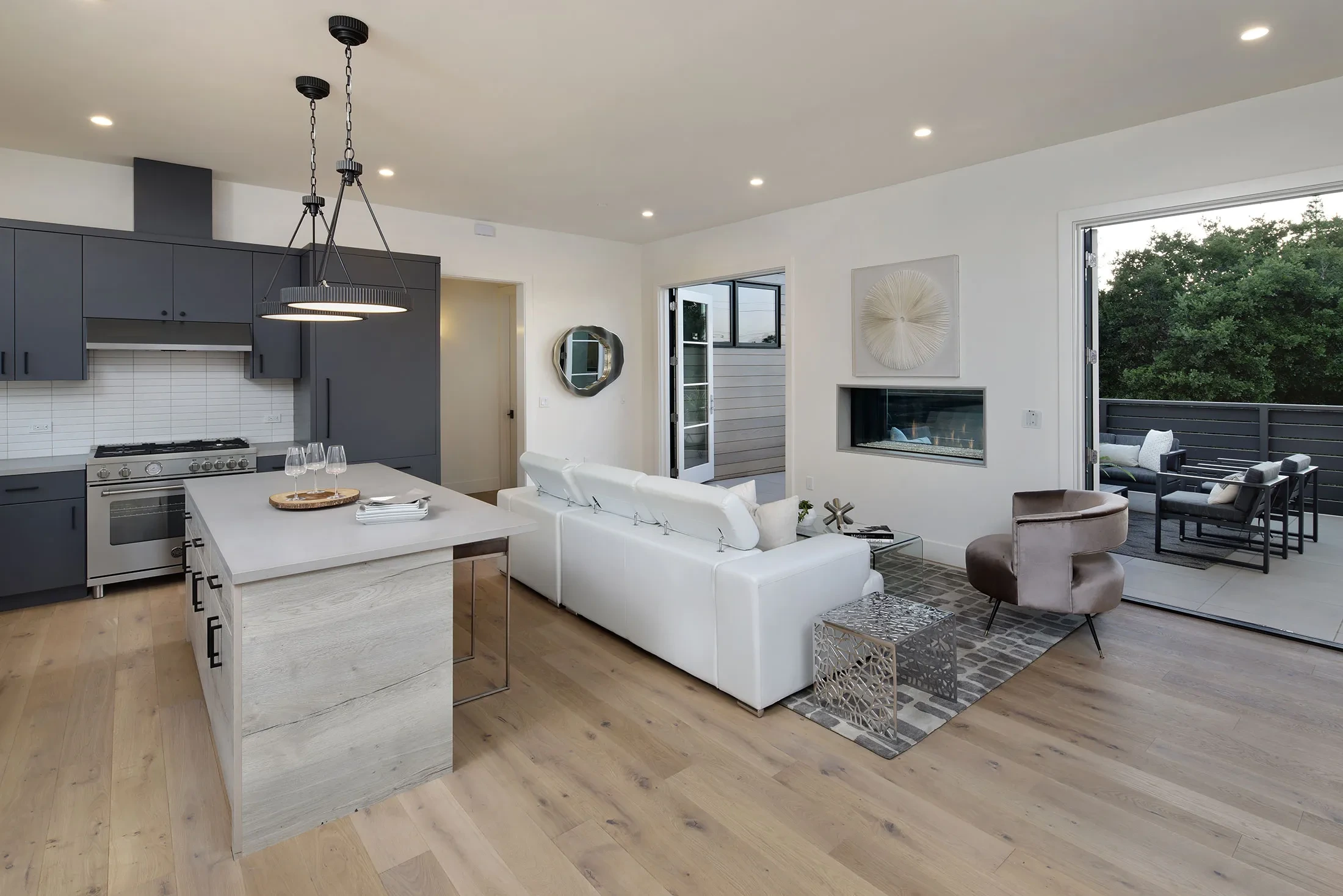 University Drive by GHG Builders — great room with kitchen island and open plan living